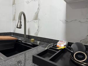 a kitchen with a black sink and a counter at BNG Suites 2 in Jwaneng
