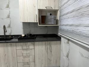 a kitchen with wooden cabinets and a counter top at BNG Suites 2 in Jwaneng
