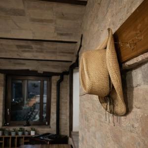 a straw bag hanging on a stone wall at Tenuta Gran Bosco in Loro Piceno