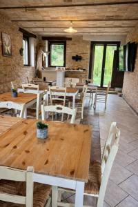 a dining room with wooden tables and chairs at Tenuta Gran Bosco in Loro Piceno
