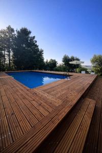 a wooden deck next to a swimming pool at Tenuta Gran Bosco in Loro Piceno