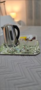 a tray with a coffee pot and glasses on a table at The comfort 2 in Raches