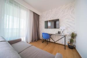 a living room with a couch and a desk at Hotel Crystal in Orebić