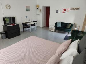 a bedroom with a bed and a table and chairs at Retiro das Camélias 3 in Lajes das Flores