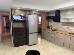a kitchen with a refrigerator with a tv in it at Sol y Sal in Torrevieja