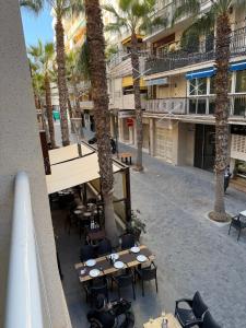 a view from the balcony of a hotel with tables and palm trees at Sol y Sal in Torrevieja