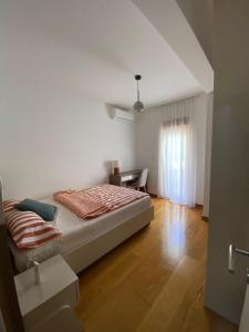 a bedroom with a bed and a desk in it at Przno central seaside in Pržno