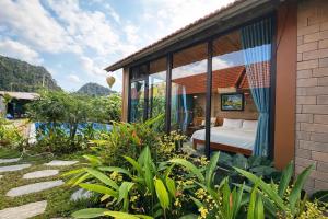 a room with a bed and some plants at Trang An Green Retreat Homestay in Ninh Binh
