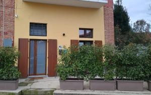 a house with pots of plants in front of it at La Casetta in Burago di Molgora