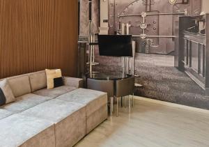 a living room with a couch and a piano at The Vault Liverpool City Centre sleeps 4 in Liverpool