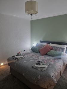 a bedroom with a bed with two trays on it at Plum Cottage in Keswick +22 photos