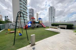 a playground with a slide and a swing set at Studio Mandarin + spectacular view + Umarizal in Belém