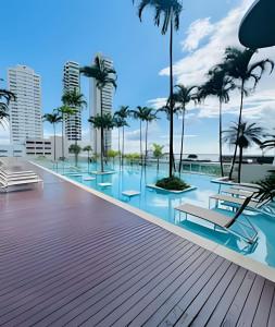 a resort with palm trees and a swimming pool at Studio Mandarin + spectacular view + Umarizal in Belém