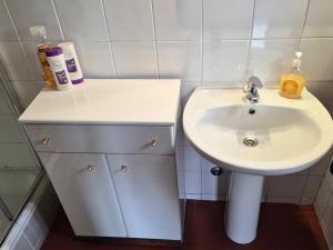 a bathroom with a sink and a white sink at Studio in peaceful village of São Martinho das Amoreiras in São Martinho das Amoreiras +13 photos