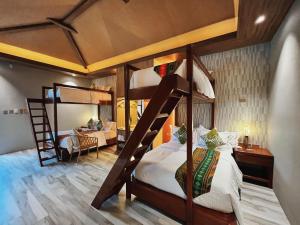 a bedroom with two bunk beds and a desk at Kenjelo Farm and Recreation Resort in Dullan