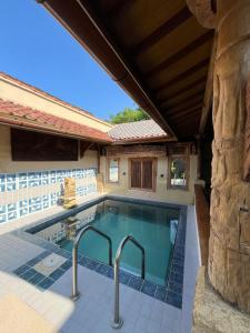 a swimming pool in a house at Amelia Villa in Montongbuwoh