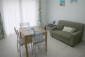 a living room with a couch and a table at Casa Ventitré in Balestrate