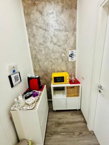 a small kitchen with a microwave on a counter at Sea Beach Pozzallo in Pozzallo +50 photos