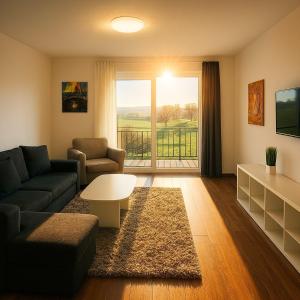 a living room with a couch and a table at Westerwald Apartments - Das große Ferienhaus, zentral und ruhig, einfach gut! in Heiligenroth