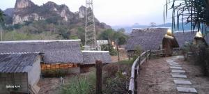 a group of houses with mountains in the background at Khao Sok Moon Light Hill Camp in Khao Sok National Park