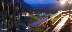a view from the top of a mountain at night at Khao Sok Moon Light Hill Camp in Khao Sok National Park +11 photos