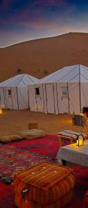 a group of tents in the middle of a desert at Camp atlantic chegaga in Mhamid +66 photos