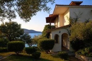 a white house with a view of the water at Blue Dandelion in Paliouri +22 photos