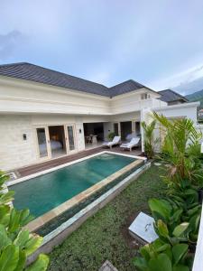 a house with a swimming pool in front of it at the gosana in Amed