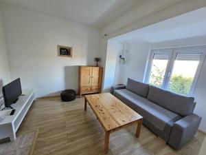 a living room with a couch and a table at Bányász Vendégház in Csokvaomány