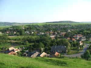 an aerial view of a small village in a green field at Bányász Vendégház in Csokvaomány