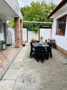 a patio with a black table and chairs at Covenant Place in Cape Town