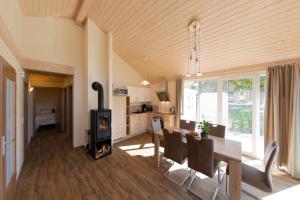 a kitchen and dining room with a table and a wood stove at Patryzia in Lenz