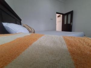 a bedroom with a bed with an orange and white blanket at AIRA in Galle +26 photos