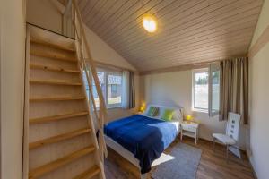 a small bedroom with a bed and a staircase at Patryzia in Lenz