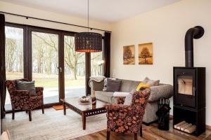 a living room with a couch and a fireplace at Aga Seeromantik Ben in Lenz