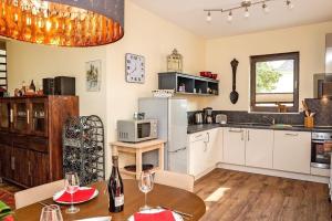 a kitchen with a table and a refrigerator at Aga Seeromantik Ben in Lenz