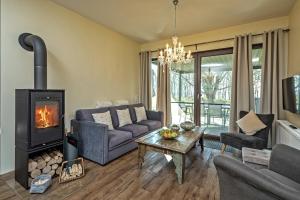 a living room with a couch and a fireplace at Aga Seeromantik Ben in Lenz +9 photos