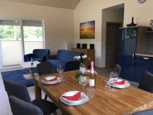 a dining room with a wooden table and chairs at Kerstin in Lenz