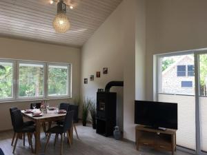 a dining room with a table and a television at Kerstin in Lenz
