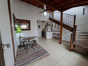 a living room with a table and chairs and a kitchen at Buzios Casa n#1 in Búzios
