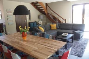 a living room with a table and a couch at Seehaus in Lenz