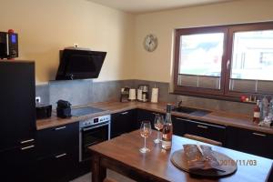 a kitchen with a table with wine glasses on it at Seehaus in Lenz