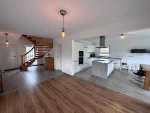 a large kitchen and living room with a staircase at Seemöwe in Lenz
