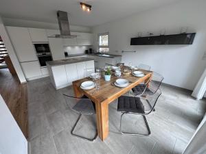a dining table and chairs in a kitchen at Seemöwe in Lenz