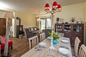 a dining room and living room with a dining table at Ben in Lenz