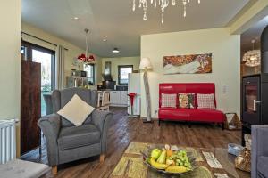 a living room with a chair and a bowl of fruit at Ben in Lenz