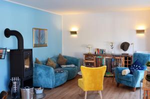 a living room with two blue couches and a fireplace at Werner in Lenz