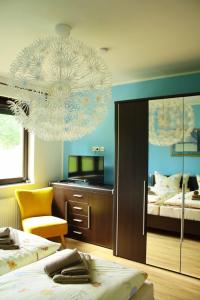 a bedroom with two beds and a chandelier at Werner in Lenz