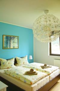a bedroom with a large bed with towels and a chandelier at Werner in Lenz