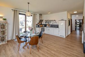 a kitchen and dining room with a table and chairs at Lago EG in Lenz